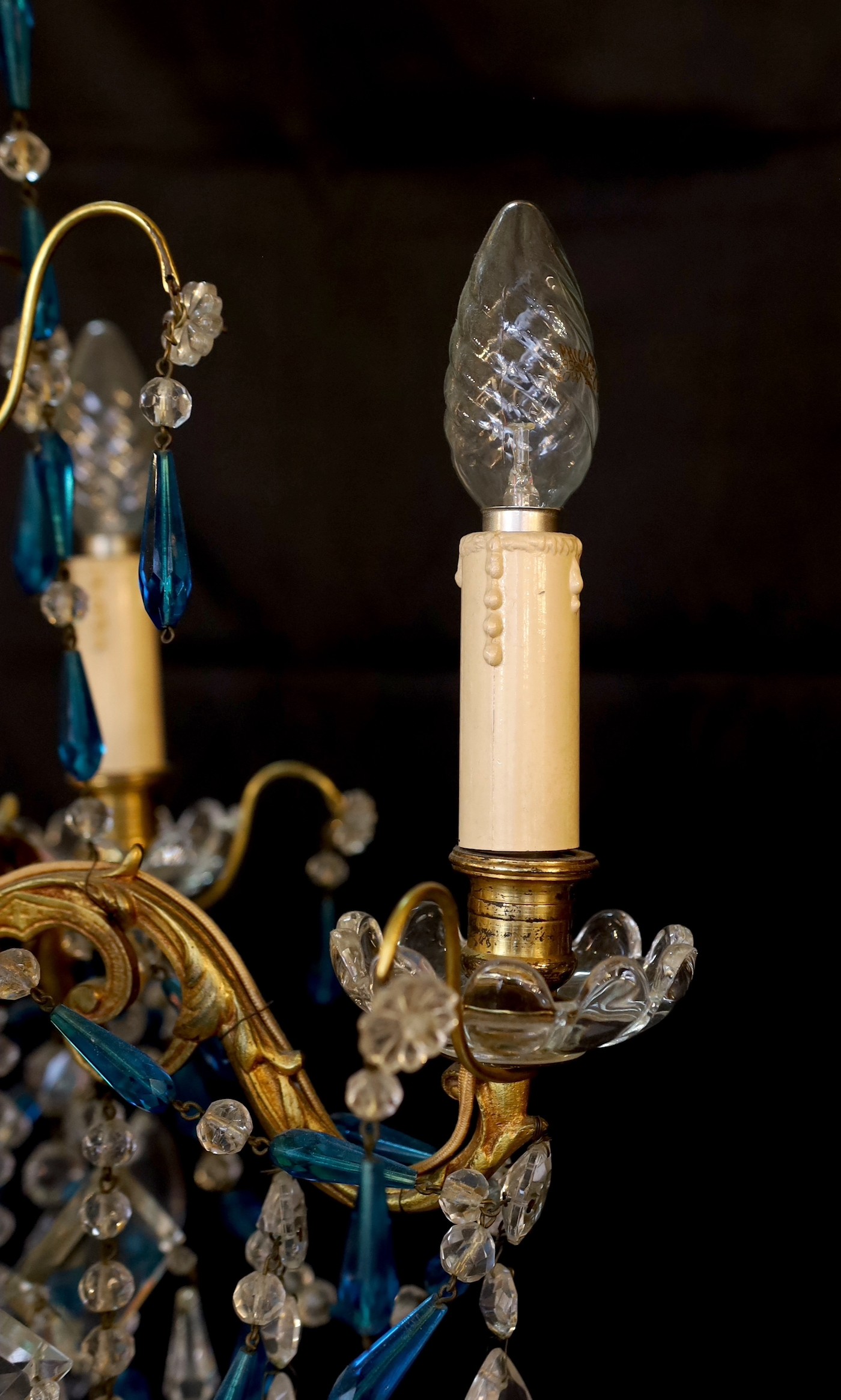 An early 20th century French gilt brass clear and blue glass four light chandelier, drop 80cm. width 40cm
